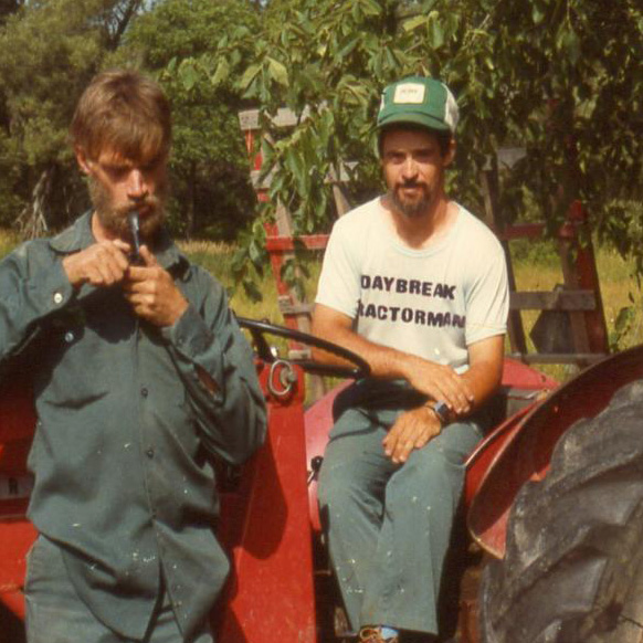 two men on a tractor
